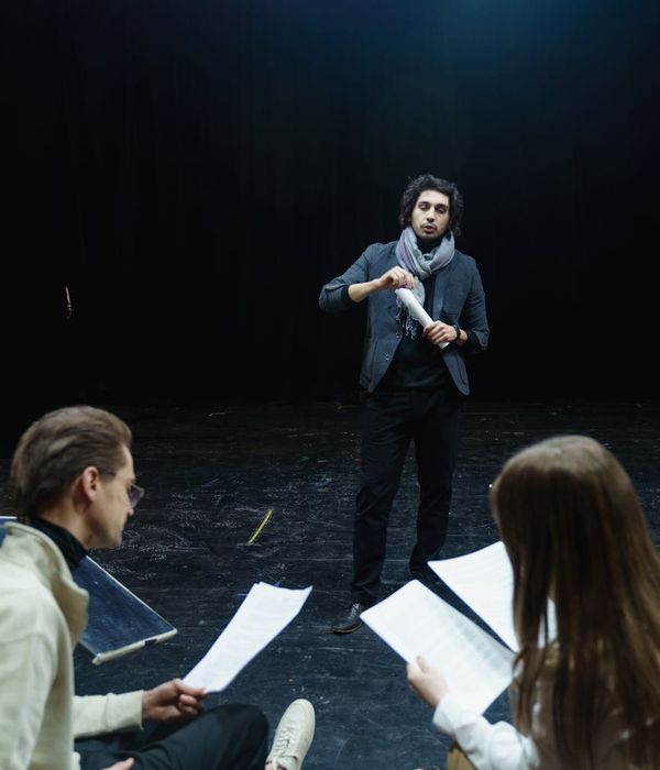 Man performing a controlled strength exercise in a dark room with honey-colored light.